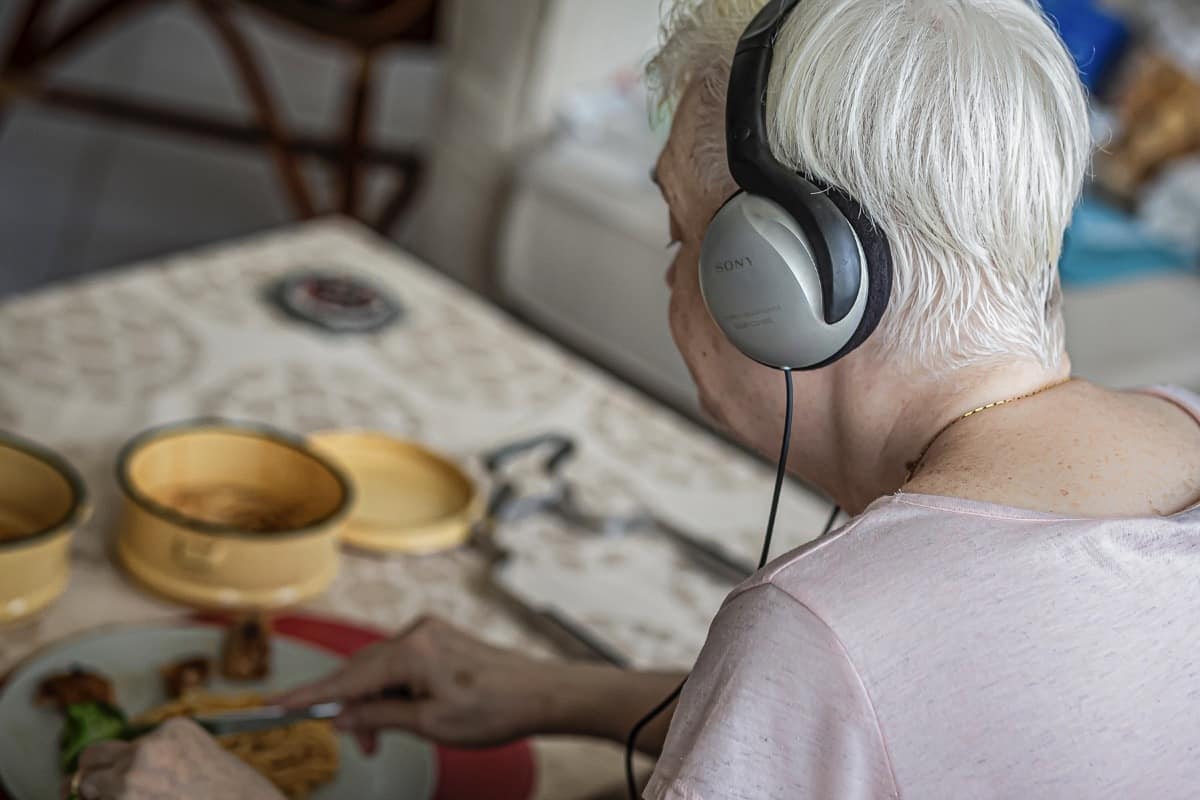 The Little Old Cooking Club That Could - a participant tuning in to the audio guide prepared by the artist. Image courtesy of TLOCCTC.