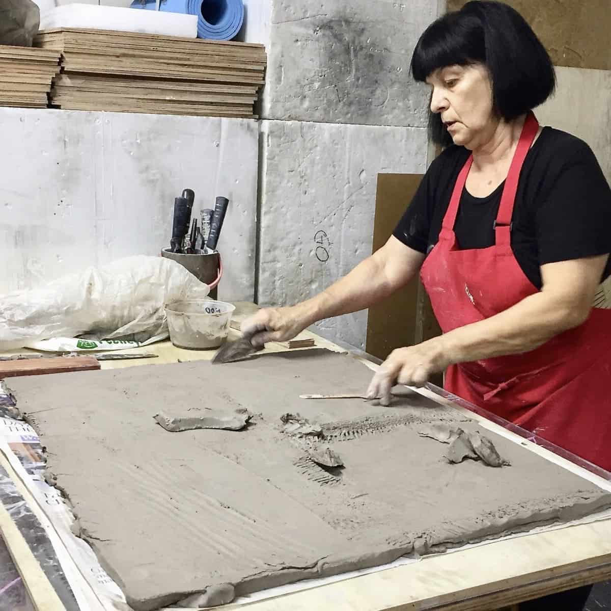 Sculptor and ceramicist Delia Prvački working in her studio. Image courtesy of the artist.