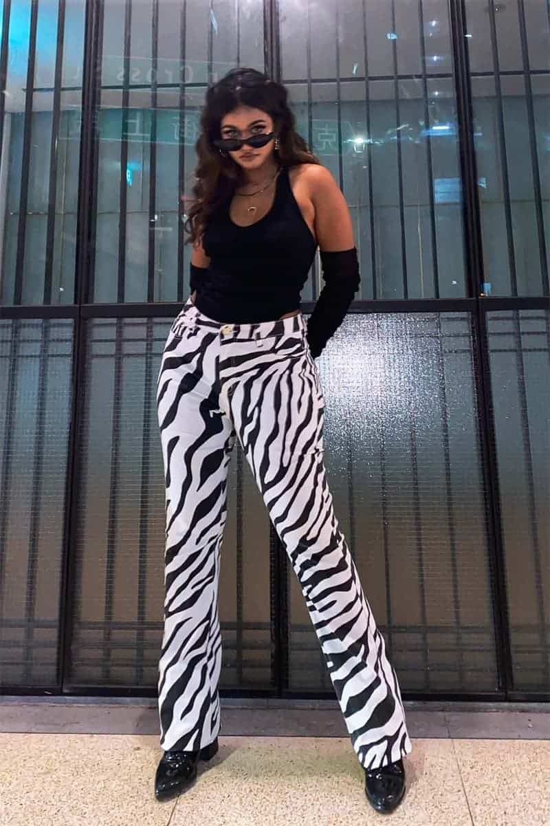 Shavita is ready to rock the town in her striking zebra print pants from Fashion Nova X Megan Thee Stallion, smart heels and svelte elbow length gloves
