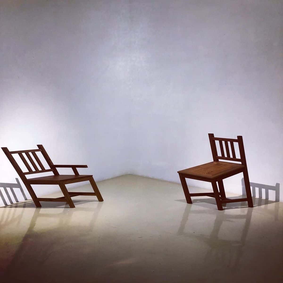 Tawatchai Puntusawasdi exhibition featuring skewed furniture (Chairs) positioned in a peculiar way
