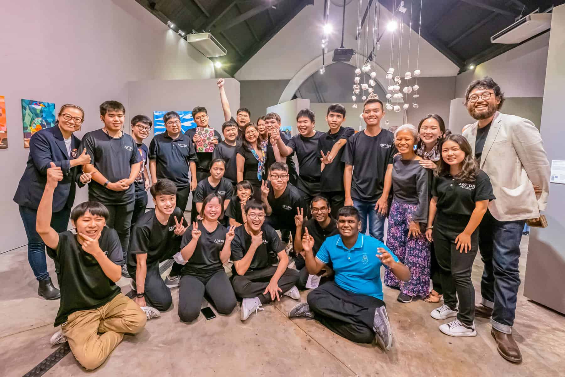Curator John Tung (far right) poses with the young artists who are part of the exhibition A Piece Of Home. Image credit: ART:DIS Singapore.
