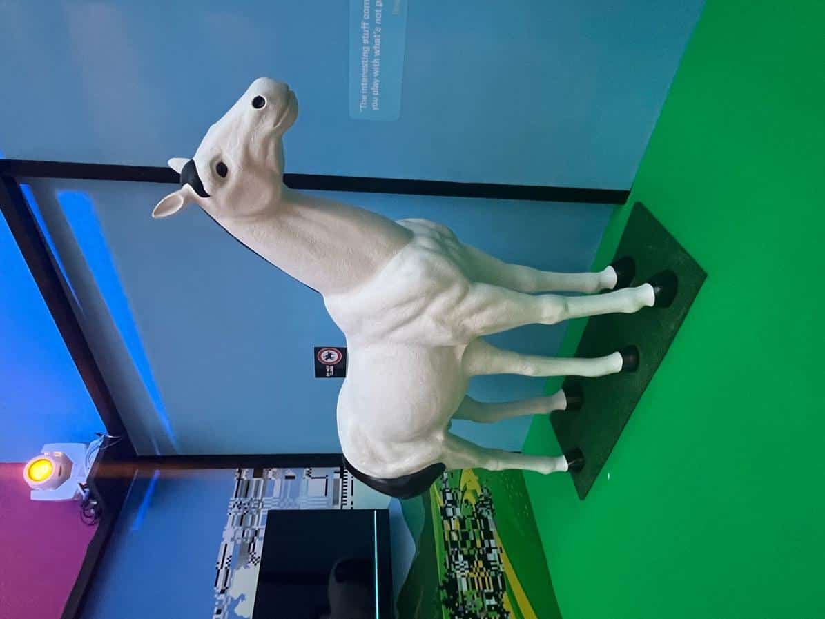 A statue of a white horse with five legs