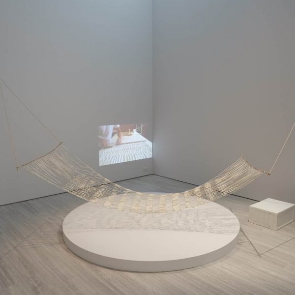 Buen Calubayan. Pasyon and Revolution: Light and Brotherhood, 2019. Hammock crafted from the second chapter of the book Pasyon and Revolution by Reynaldo Ileto. Paper, pen markings, bamboo stick, rope. Photo courtesy of Mind Set Art Center.